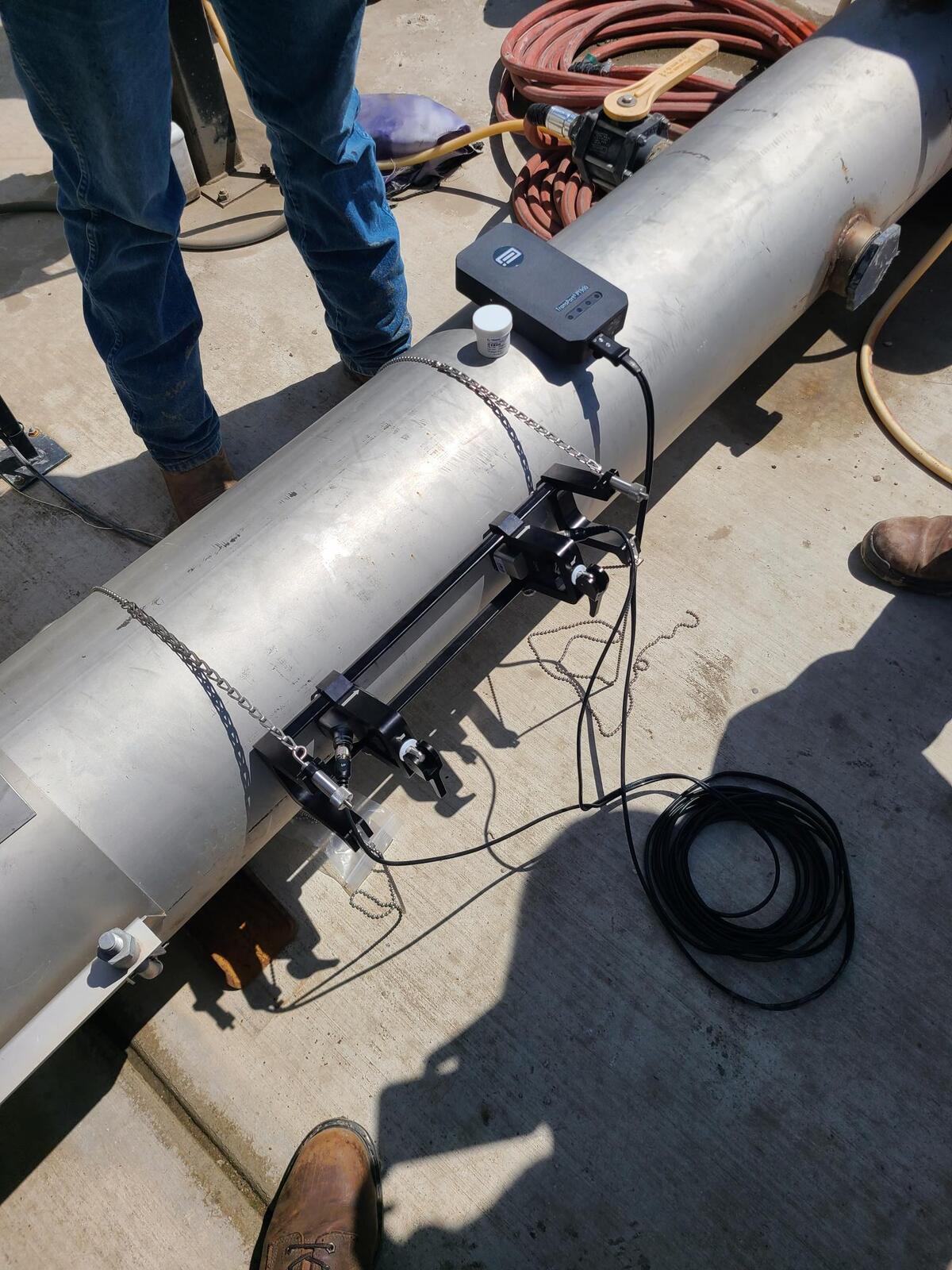 Clipper Controls field service manager installing a clamp-on flow meter