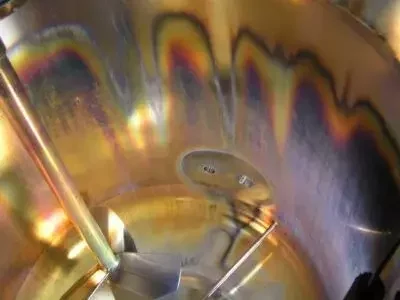 Close-up of rouging on a stainless steel surface inside process piping