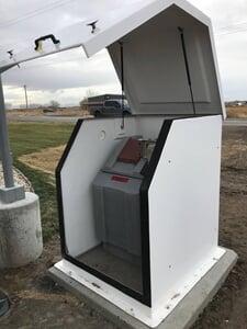 An outdoor enclosure with an ISCO 5800 water sampler inside