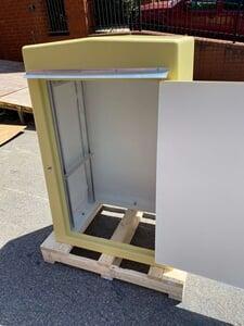 A gemeni 6 fiberglass enclosure with the door open showing the inside and open floor