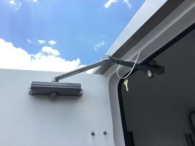 A shelter with an overhead door actuator
